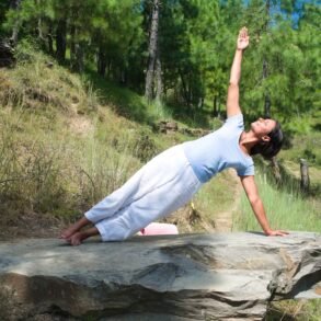 a woman doing yoga in nature for The Ayurvedic Fitness Blueprint