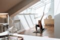 a woman exercising in her room during daytime
