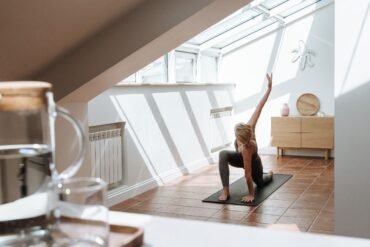 a woman exercising in her room during daytime