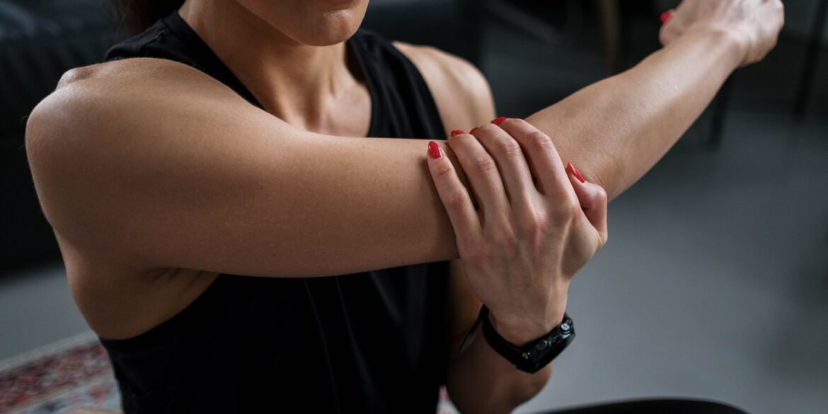 a woman massaging her arm