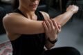 a woman massaging her arm