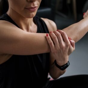 a woman massaging her arm