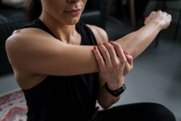 a woman massaging her arm