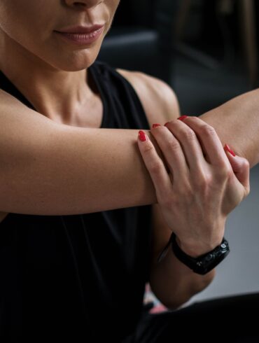 a woman massaging her arm