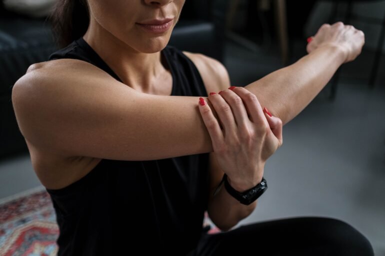 a woman massaging her arm