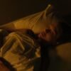 a man sleeping in his bed