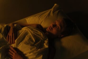 a man sleeping in his bed