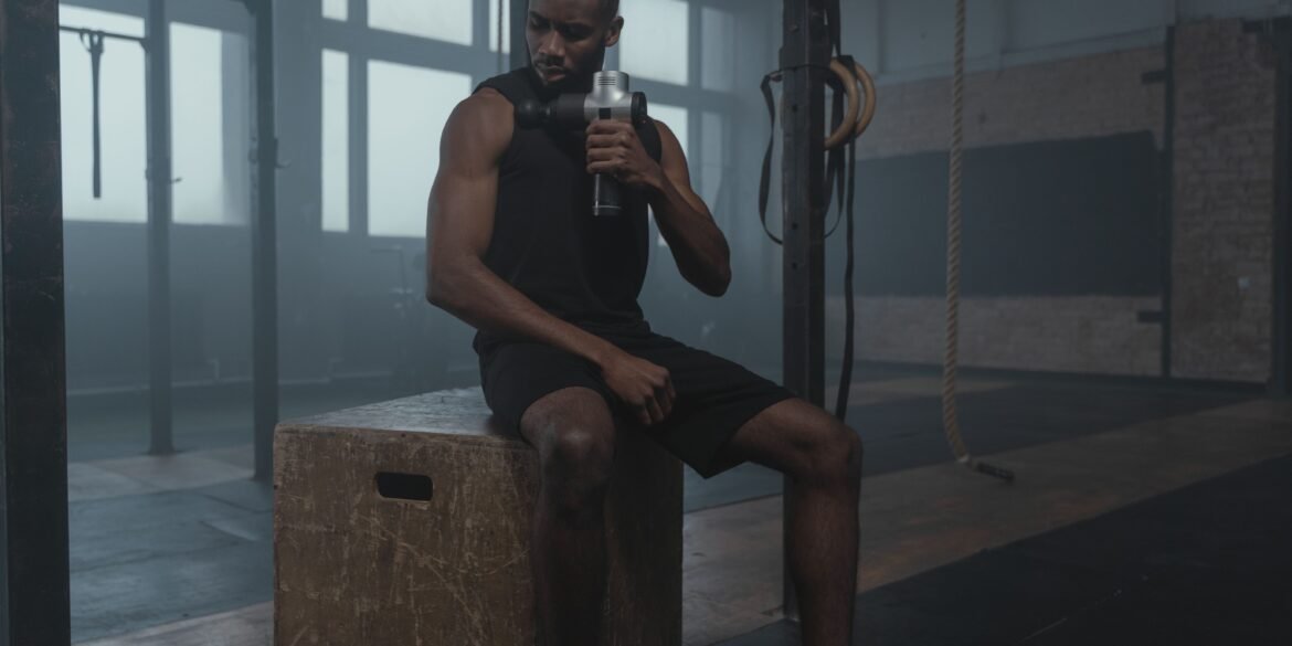 a man drinking water and taking a rest after a workout