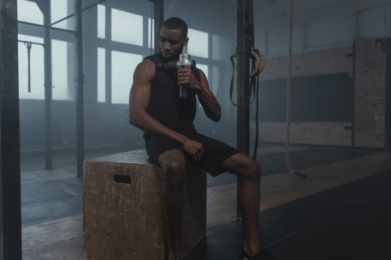 a man drinking water and taking a rest after a workout
