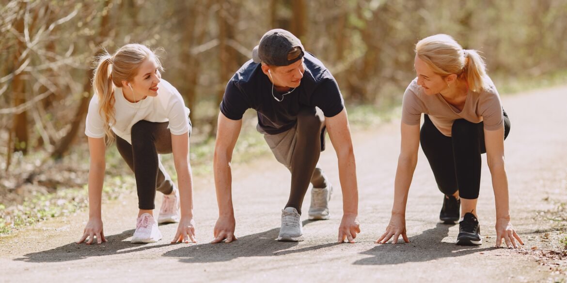 three people working out in nature