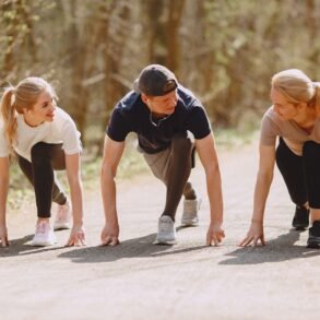 three people working out in nature