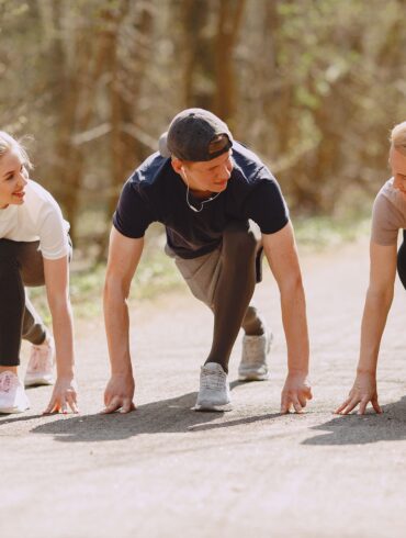 three people working out in nature