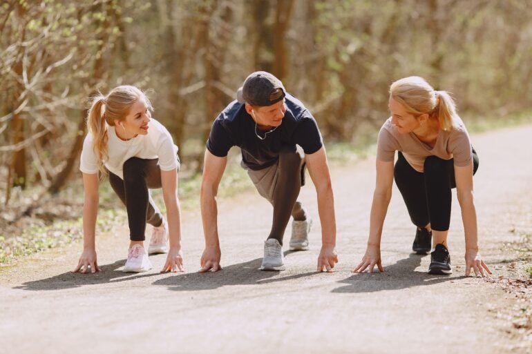 three people working out in nature