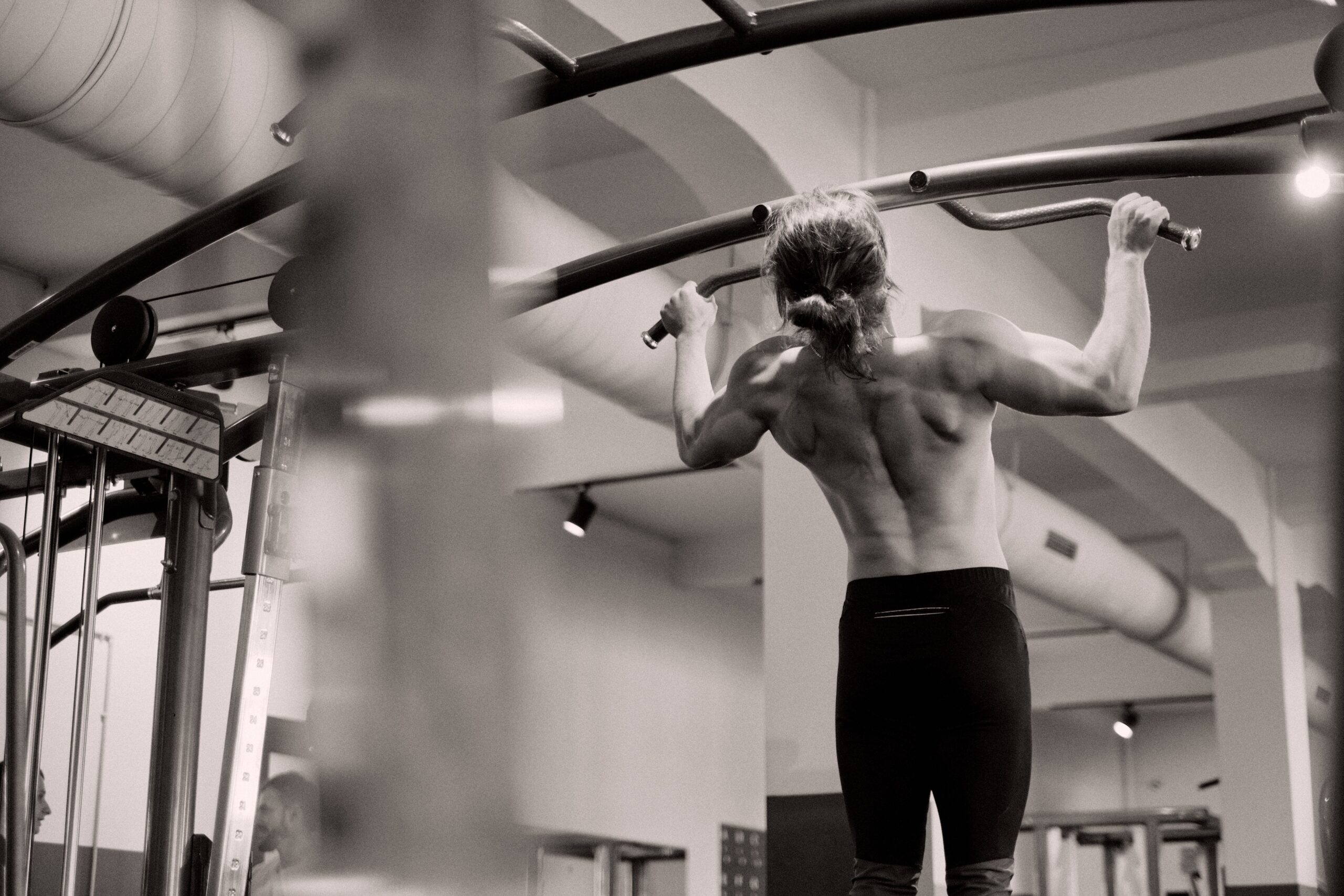 a woman in the gym doing pull ups for Stable Energy