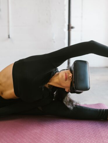 a woman doing yoga with a VR on