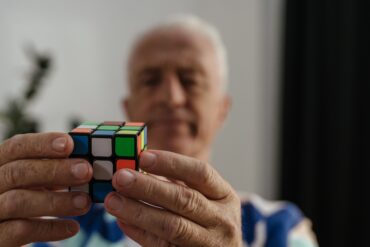 an old man solving the rubick's cube