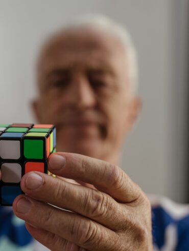 an old man solving the rubick's cube