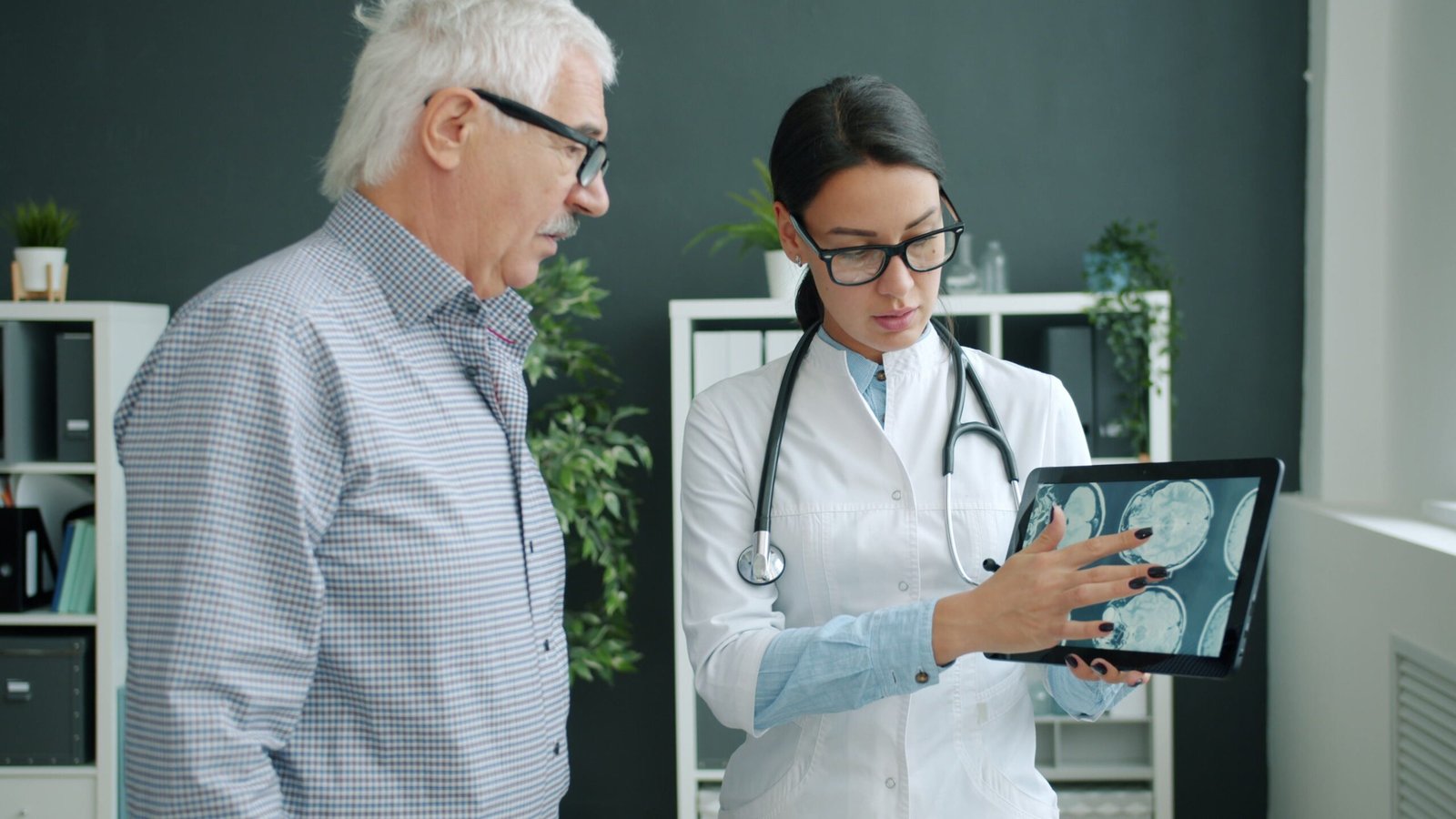 a doctor showing an old man a brain scan for memory and cognitive health