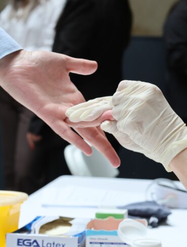 a man getting pricked with needle for blood testing
