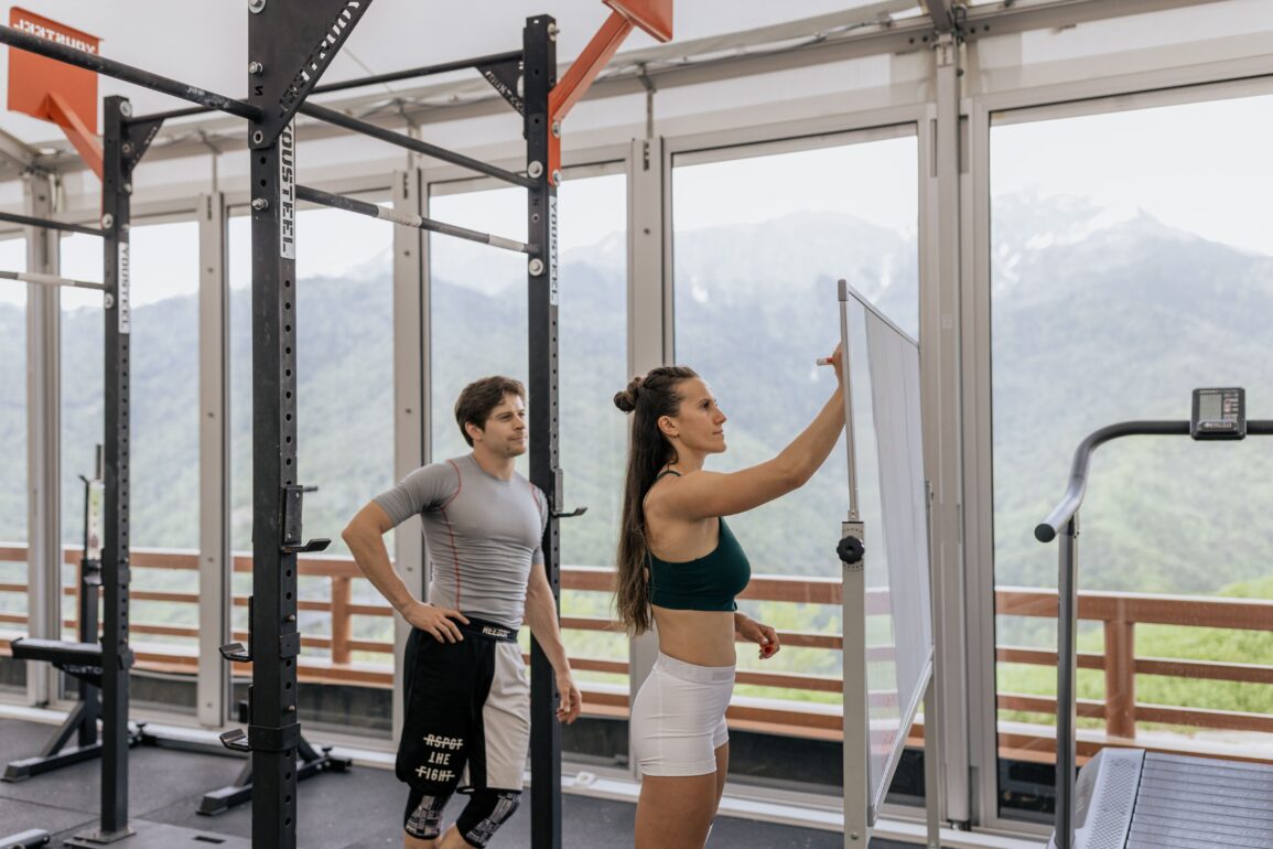 two people in the gym strategizing their workout