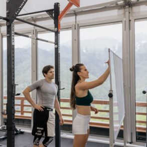 two people in the gym strategizing their workout
