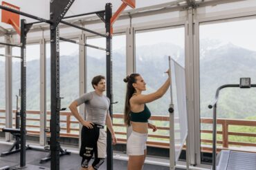 two people in the gym strategizing their workout