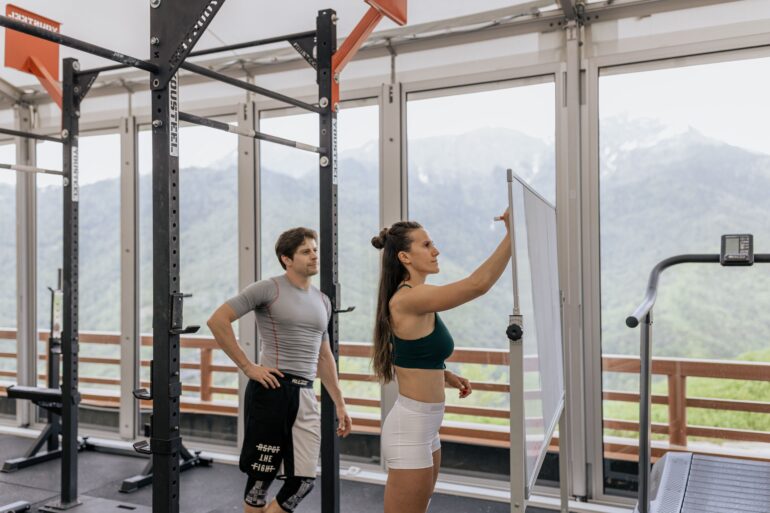 two people in the gym strategizing their workout