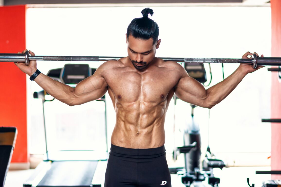 a man lifting weights in the gym