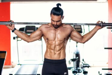 a man lifting weights in the gym