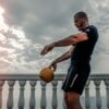 a man lifting weights on his roof