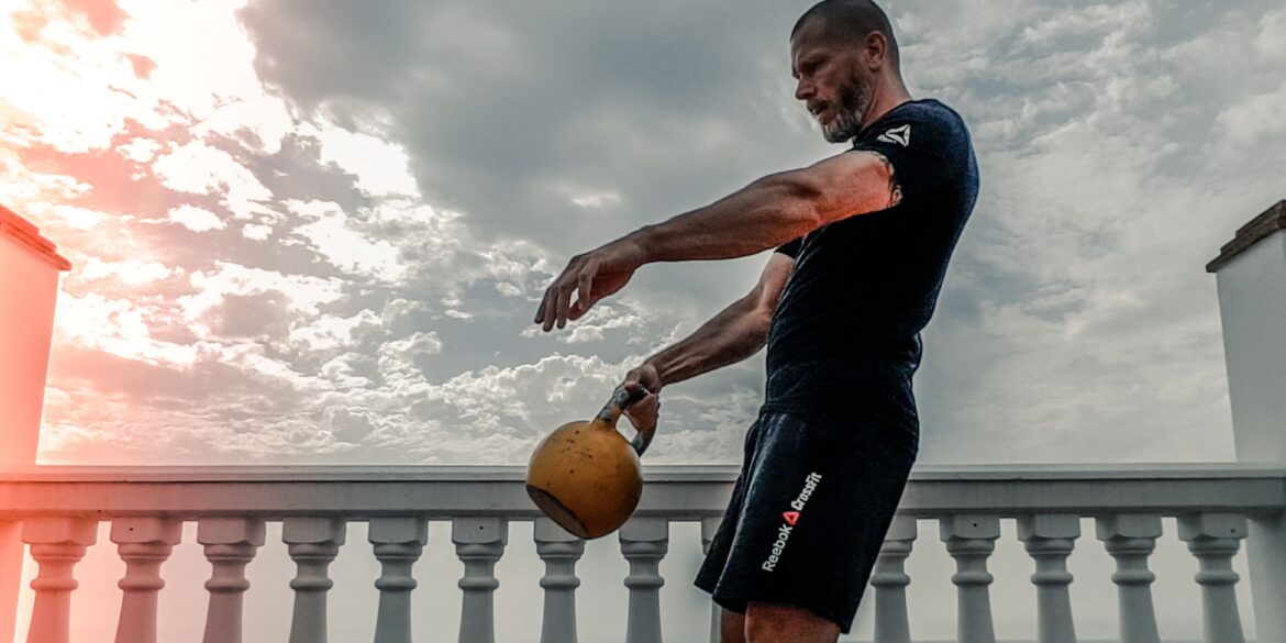 a man lifting weights on his roof