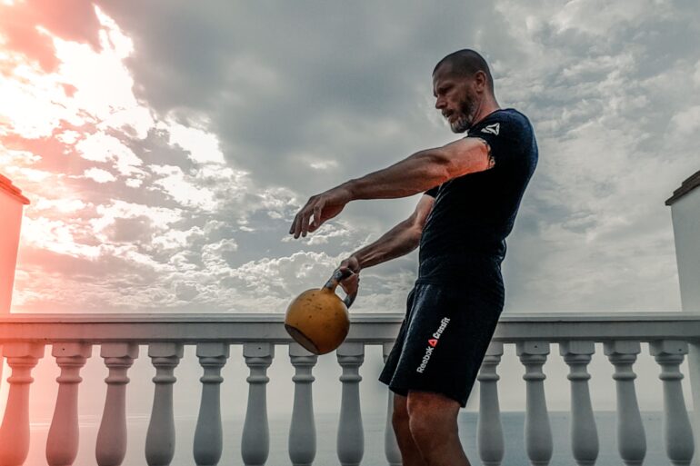 a man lifting weights on his roof