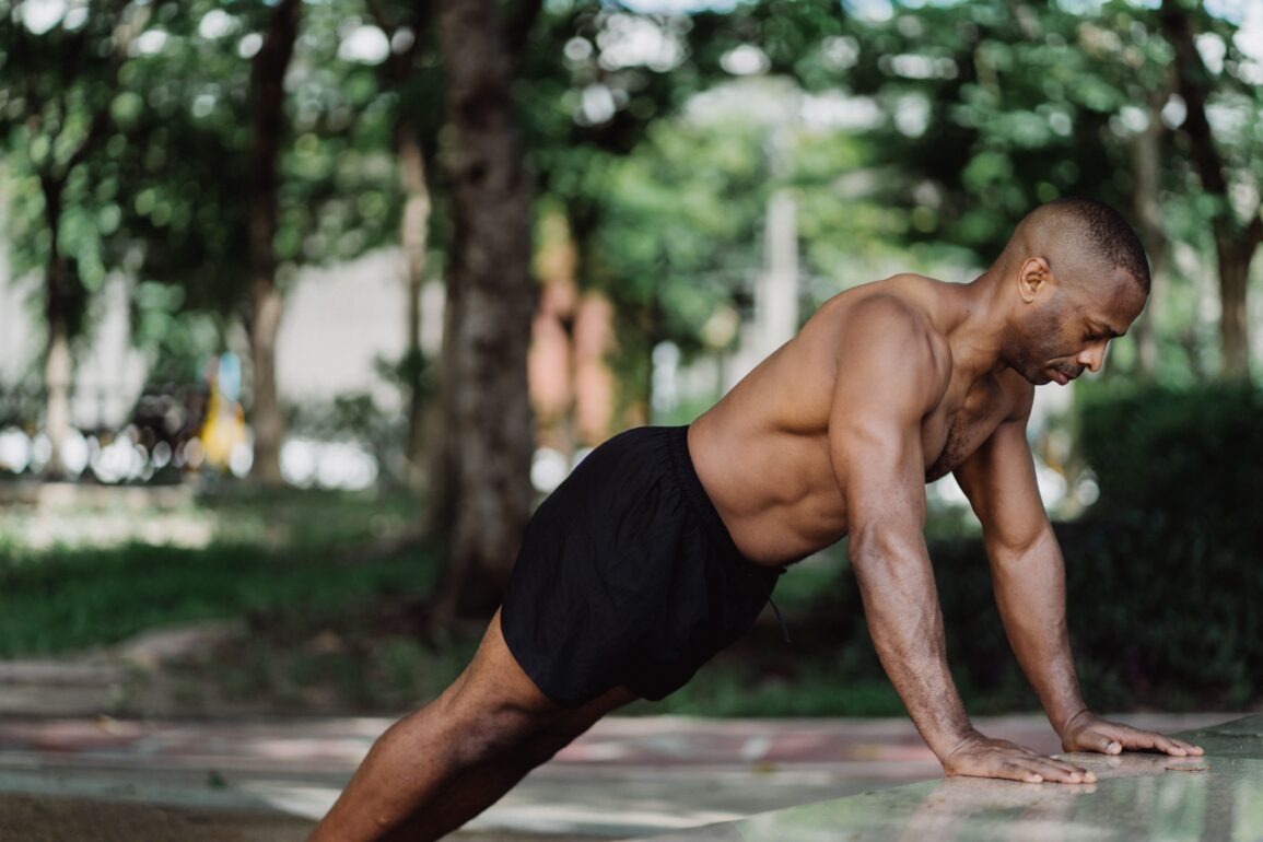 a man doing push-ups in nature