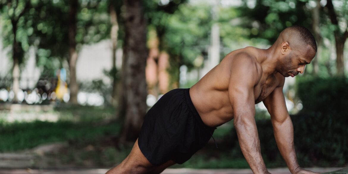 a man doing push-ups in nature
