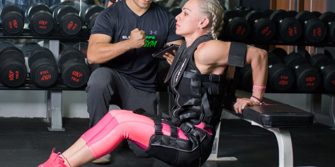 a woman training in the gym with a trainer