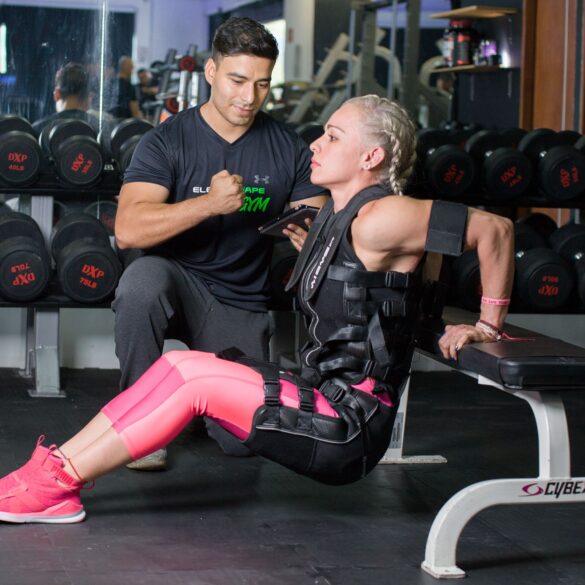 a woman training in the gym with a trainer