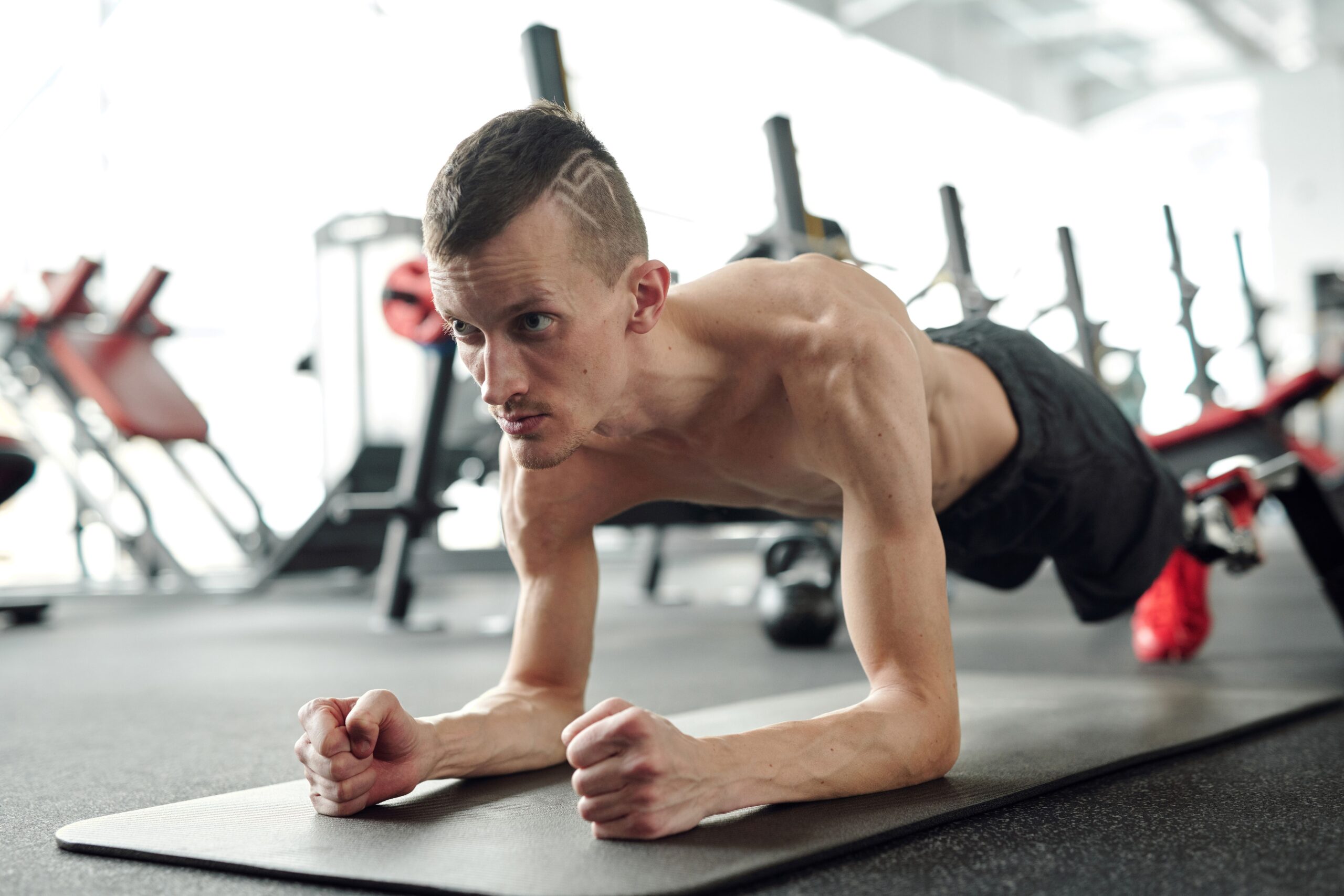 a man doing plank in gym for Stronger Core