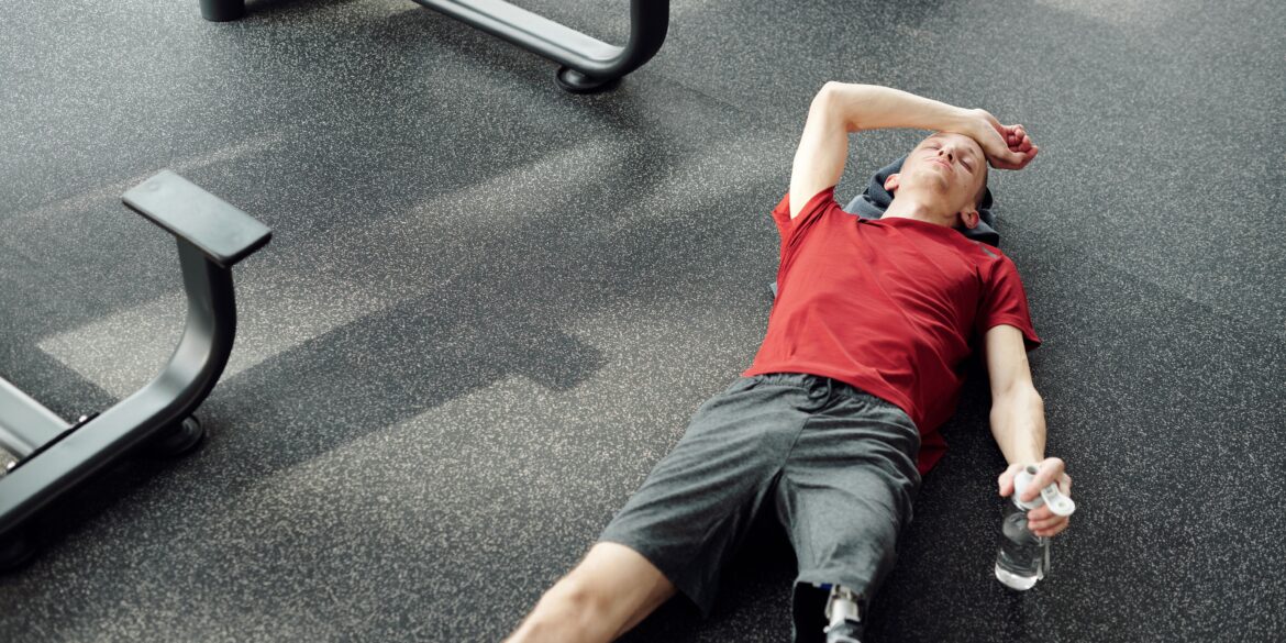 a man resting after working out in the gym