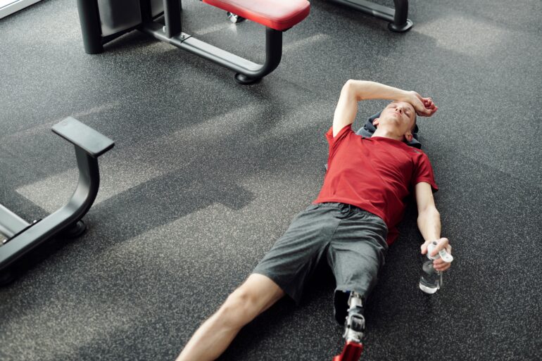 a man resting after working out in the gym